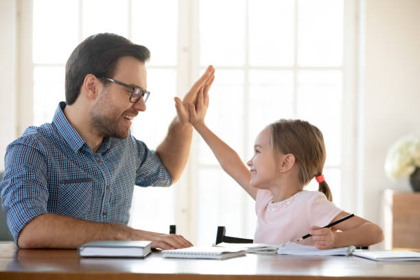 istock Happy father and little daughter celebrate study achievement 1311677300
