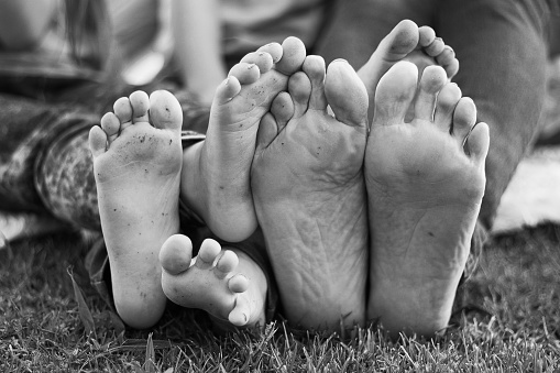 Grandmother and grandchildren's feet