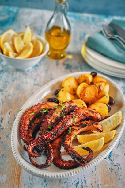 istock Octopus Tentacles with Potatoes and Fresh Lemon 1311680571