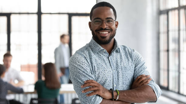 istock Confident black leader standing at modern company office feeling proud 1311682045