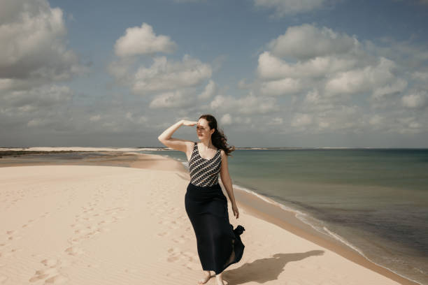 istock Woman walking on a dune 1311683537