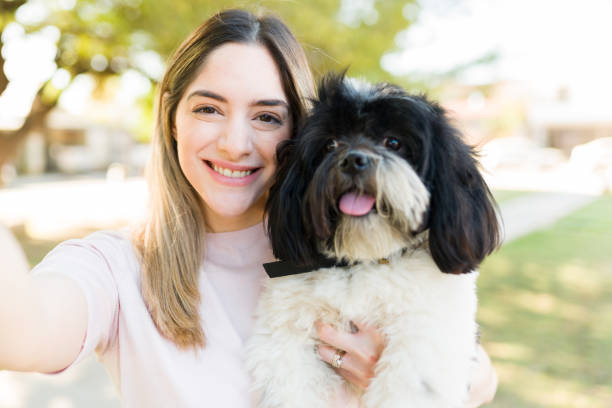 istock Dog owner hugging her puppy and taking a selfie 1311684363