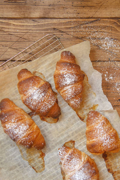 istock French fresh crusty croissants on a wooden table top view 1311687055