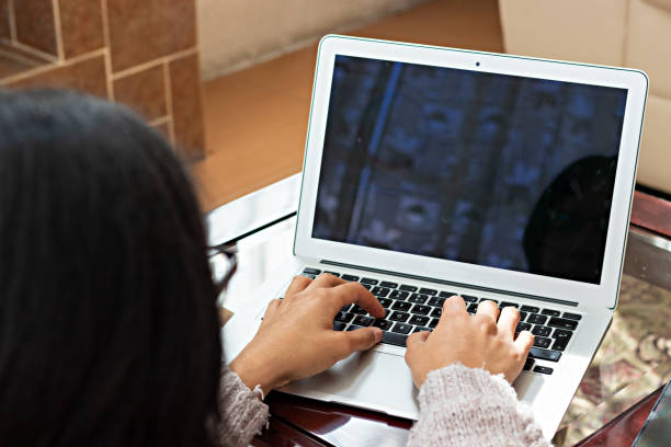 istock young man sitting in armchair, doing home office, typing on laptop 1311688316