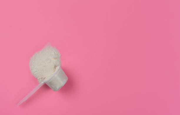 istock Collagen powder in a measuring spoon on a red solid background top view with copy space. Supplemental protein intake, natural supplement layout for skin and bone beauty and health. 1311689335