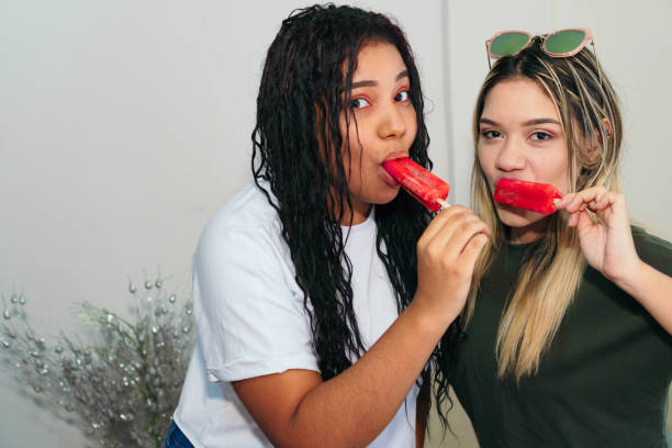 istock Two Hispanic friends at home 1311690271