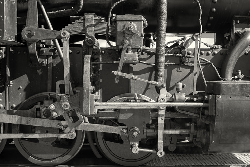 Retro steam train moves in the summer forest.