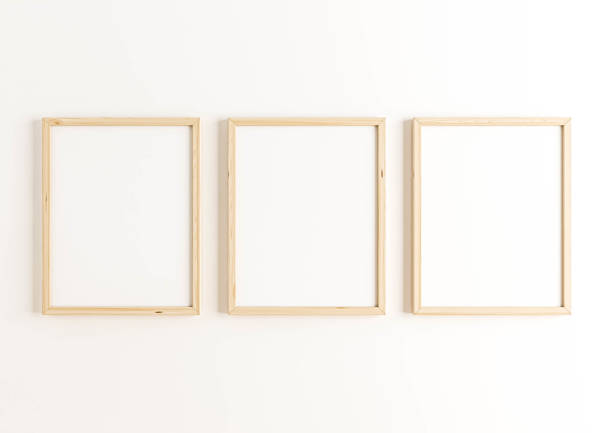 istock Triple 8x10 Vertical beige Frame mockup on white wall. 1311691381