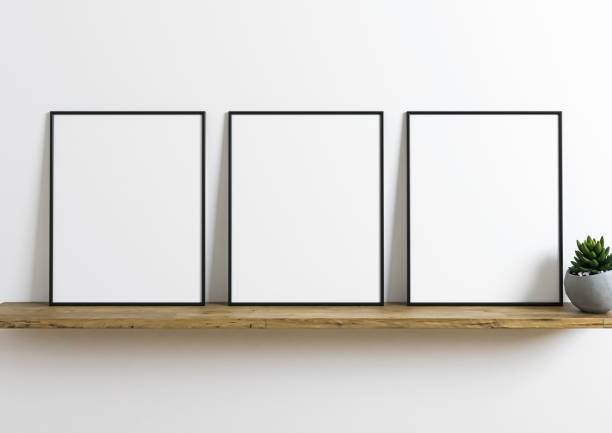 istock Triple 8x10 Vertical black Frame mockup on wooden shelf and white wall. 1311692341
