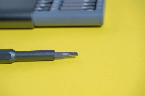 istock A set of screwdrivers with bits in a case on a yellow background. Tools for work. the screwdriver is next to the set 1311695487