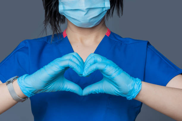 istock Doctor making heart shape with hands. Gray background 1311698509