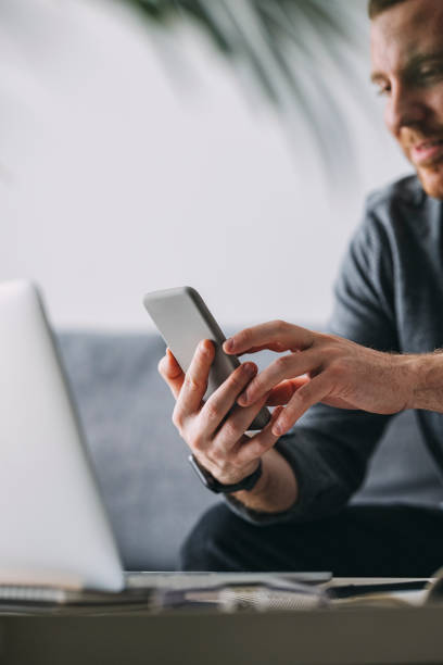 istock Work At Home: Man With Smartphone And Laptop 1311706445