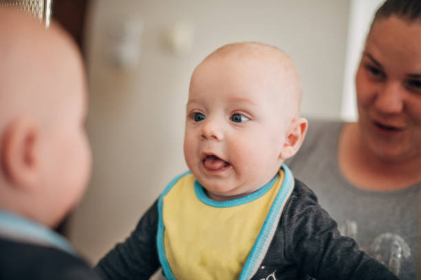 istock Baby boy goofing around in mirror 1311708303