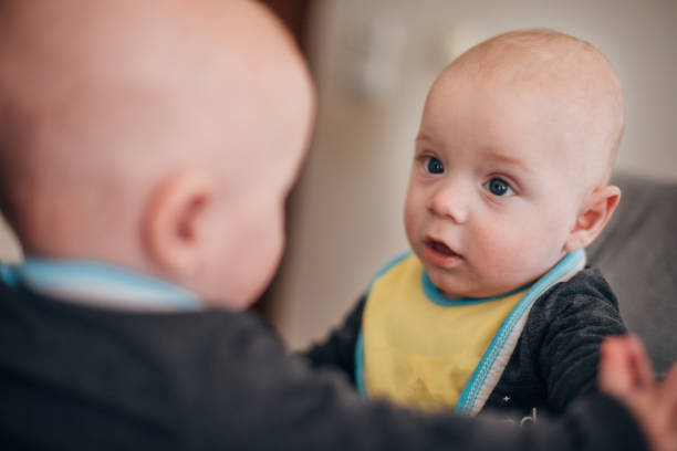 istock Baby looking at mirror and wondering 1311708471