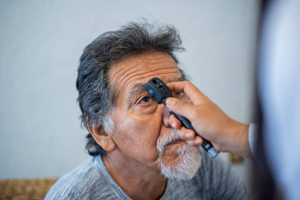 doctor checking mr. Adult's Eyes