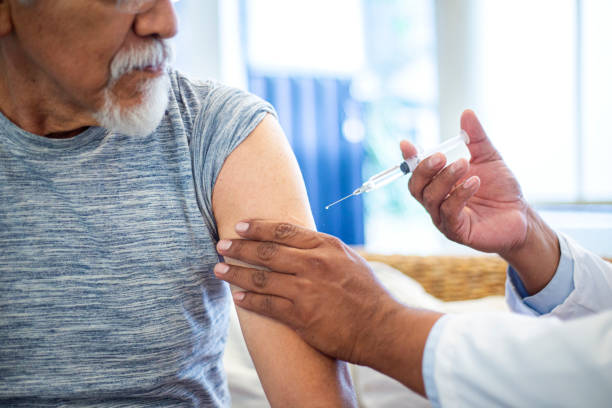 istock doctor injecting older man 1311709410