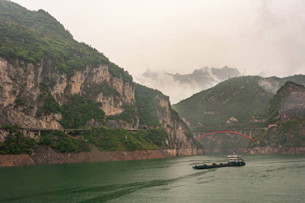 istock Coal barge sails in Zigui region on Yangtze River, China. 1311710528