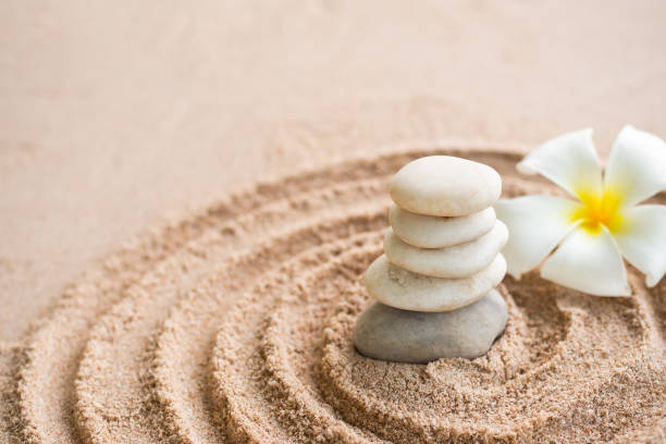 istock Japanese zen garden stone on sand beach. 1311720570
