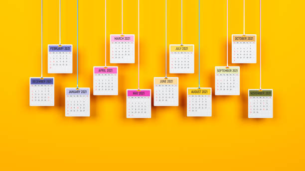 Suspended monthly calendar pages on yellow-colored background Suspended monthly calendar pages on yellow-colored background Horizontal composition with copy space annual event stock pictures, royalty-free photos & images