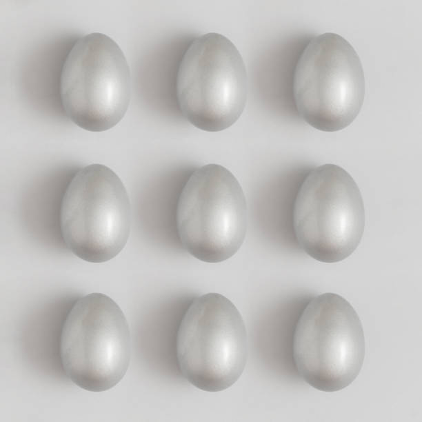 Pattern made of silver easter egg on a gray background. Minimal holiday concept. Flat lay, top view.
