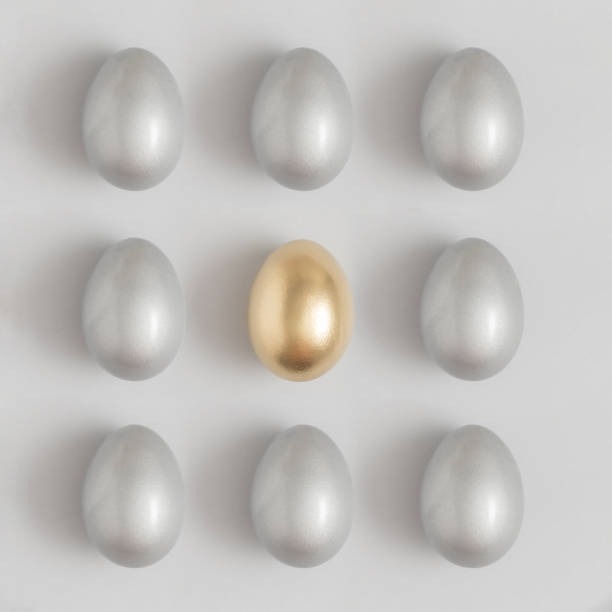 istock Pattern made of silver and gold easter egg on a gray background. Minimal holiday concept. Flat lay, top view. 1311731689