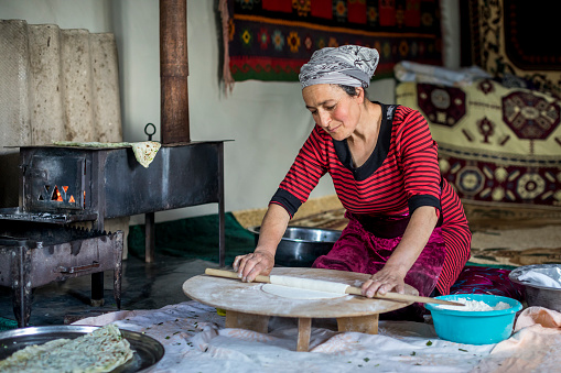 Keneye village, Azerbaijan: Woman, living in remote area in mountains,  preparing qutab flatbread in a traditional way.
