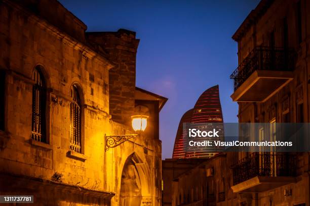 Old City In Baku At Dusk With Modern Flame Towers In Background Stock Photo - Download Image Now