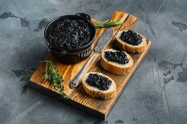 istock Sandwiches with black caviar, on gray background 1311740271