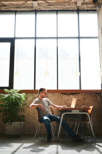 istock Young man studying or working in laptop in cafe. 1311741114