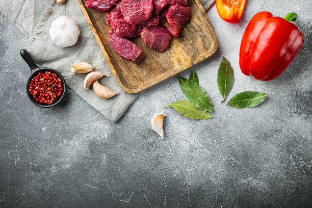 istock Beef stew raw ingredients, on gray stone background, top view flat lay, with copy space for text 1311743312