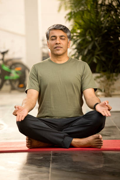 istock Man meditating in lotus position 1311744153