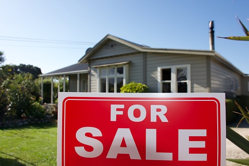 A For Sale Sign Outside a House.