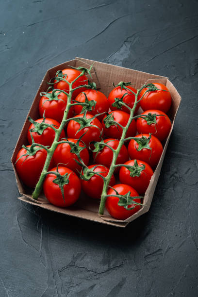 istock Ripe cherry tomatoe, on black background 1311744980