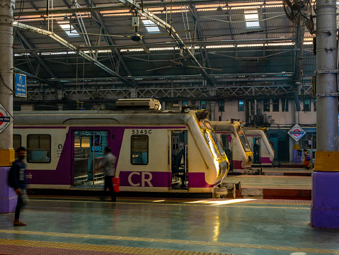 Mumbai, India - January 7, 2021 : Empty trains standing at the platform of CST station with victorian architecture, CST is one of the busiest train station for working-class people in Mumbai