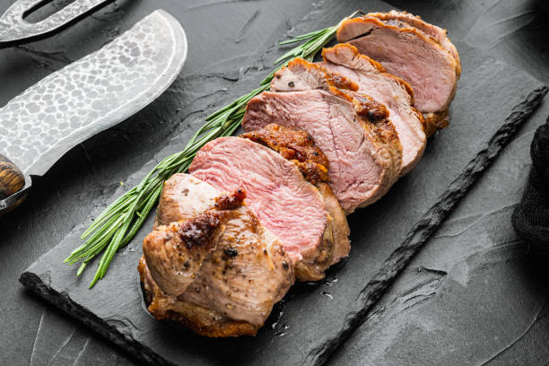 istock Grilled duck breast, on stone serving board, on black stone background 1311745212
