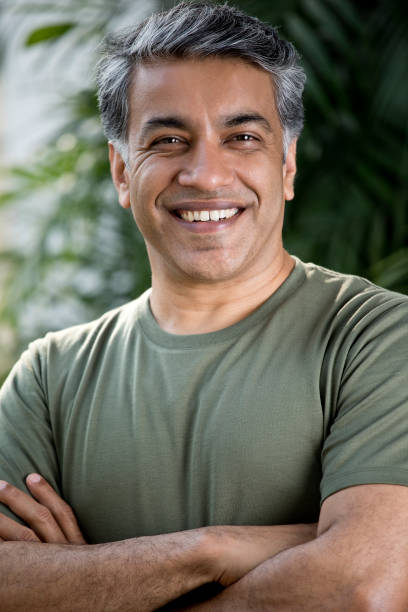 istock Happy man with arms crossed 1311745896