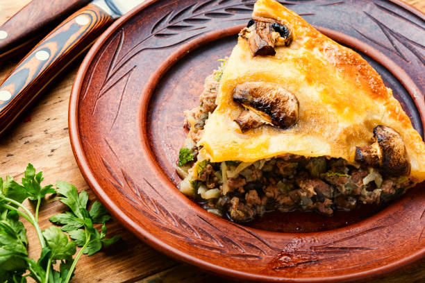 istock Whole meat pie with mushrooms,wooden background 1311746037