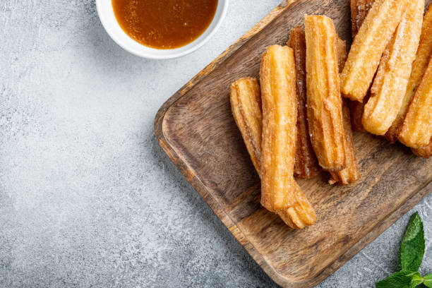 istock Churros sprinkled with powdered sugar, on gray background, top view flat lay with space for text, copyspace 1311746105