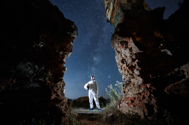 istock Spaceman in suit is holding helmet in isolated area. 1311747781