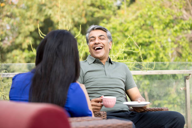 istock Loving couple talking while drinking coffee on apartment terrace 1311748024