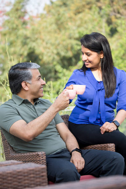 istock Loving couple talking while drinking coffee on apartment terrace 1311748207