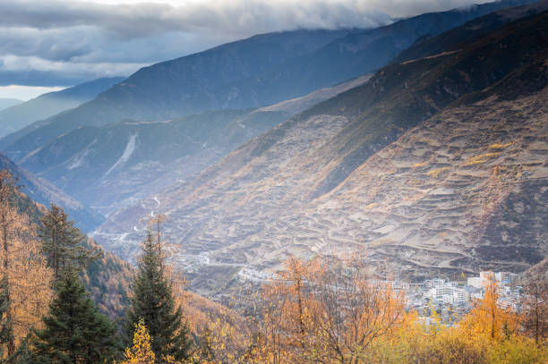 istock Asian landscape with mountain peaks, hills, forests and fields, cloudy sky. 1311748834