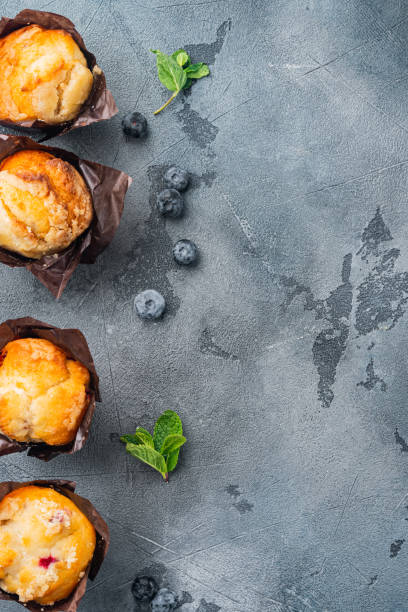 istock Blueberry muffins with fresh berries, on gray background, top view flat lay with copy space for text 1311748966
