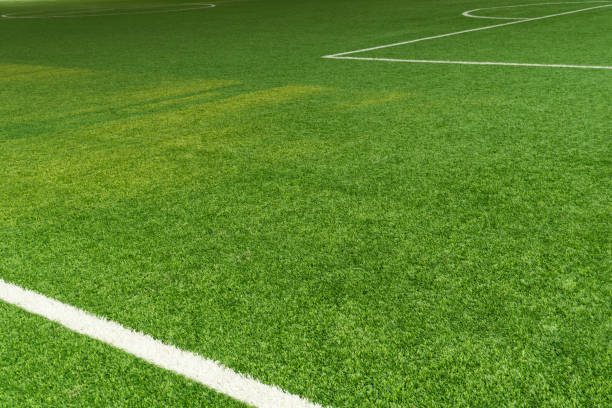 istock green artificial grass football field with white line 1311751512