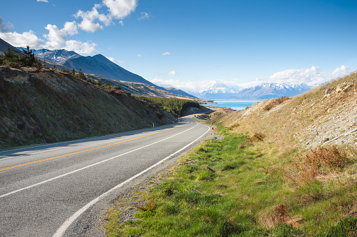Empty road to mountain at Mount Cook background in south island new zealand