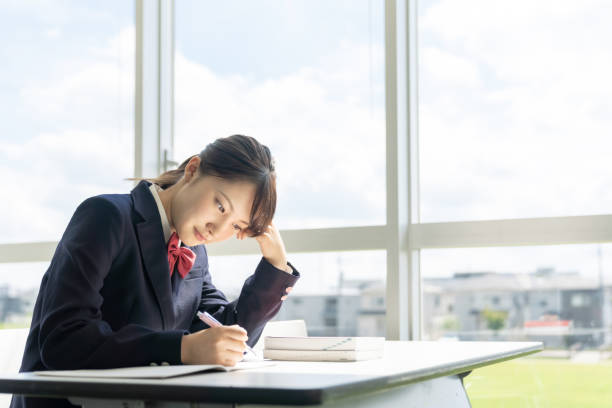 Asian female high school student studying in classroom. Asian female high school student studying in classroom. female high school student stock pictures, royalty-free photos & images