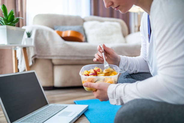 istock A woman eats a healthy fruit salad from a plate bowl. Moments with Plastics 1311761937