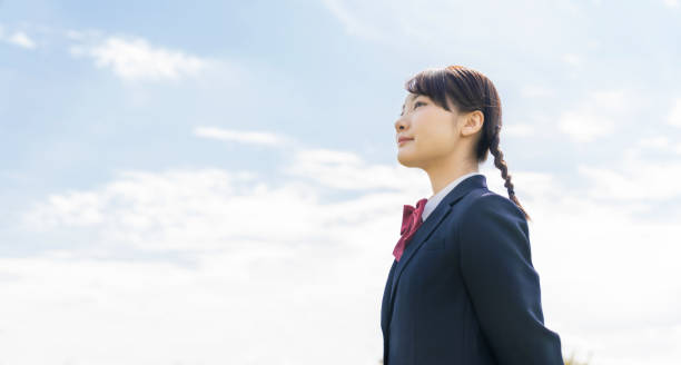 istock Asian female high school student looking up to sky. 1311763286
