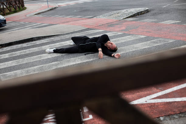 istock Traffic accident.Young man hit by a car 1311763525