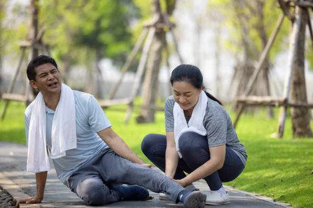 istock Asian elderly or senior man accident falling down on floor in the park while running exercise have pain knee ache. 1311766549